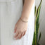 Close-up of stainless steel CZ tennis bracelet on wrist.